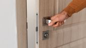 Una persona abriendo la puerta de una casa