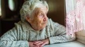 Una anciana mirando por una ventana 