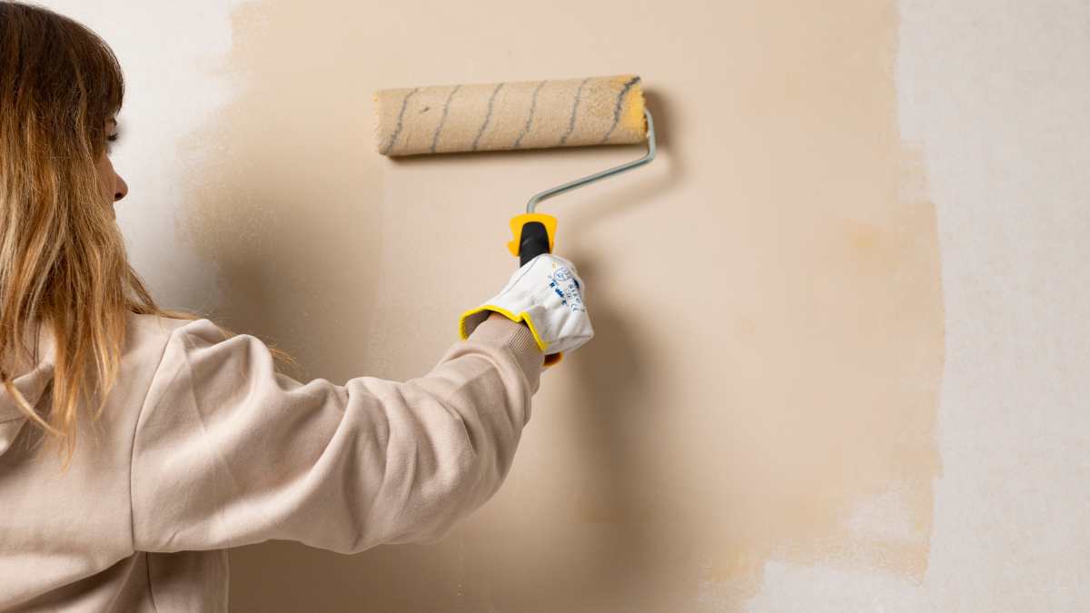 mujer pintando una pared
