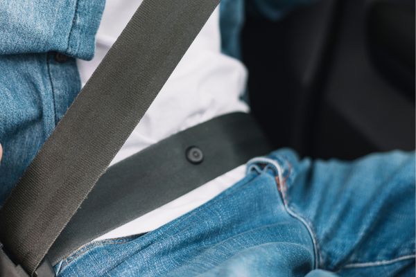 Botón en la cinta del cinturón de seguridad